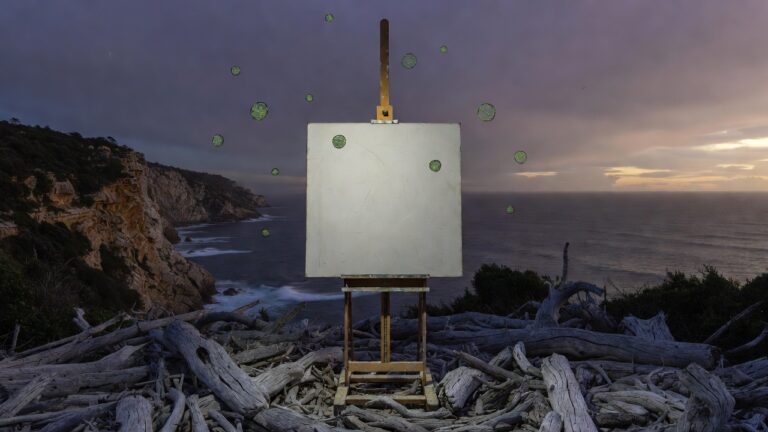 Victorian cliff twilight with blank canvas showing cracked marks and imperfect green circles on easel, rough driftwood arrangements, Bass Strait backdrop, representing CPTSD negative self-view, inner critic, shame, and gentle reframing in trauma recovery.