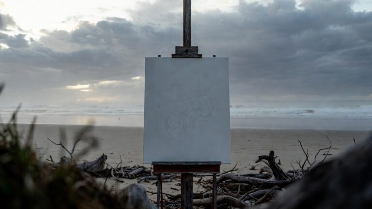 Misty Victorian beach at dawn with blank canvas displaying repetitive loops on easel, driftwood in patterns, stormy Bass Strait backdrop, representing CPTSD OCD compulsions, control struggles, and emerging awareness in trauma recovery.